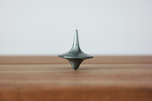 a tabletop spinner spinning and balancing on a table